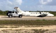Southern Air on the airstrip in Long Island Bahamas without its landing gear deployed.