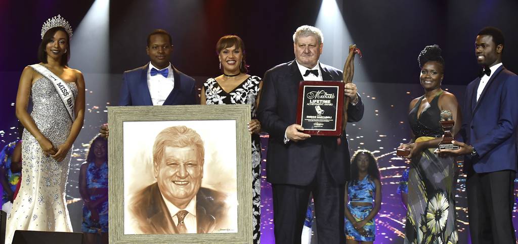 Enrico Garzaroli, owner of the historic and world-renowned Graycliff was presented the Clement T. Maynard Lifetime Achievement Award at the 17th Cacique Awards held at Baha Mar Convention Centre, Cable Beach, on Saturday, April 8, 2017. Pictured from left: Cherell Williamson, Miss Universe Bahamas; Jamal Rolle, Celebrity Artist, who produced the image of Mr. Garzaroli; Joy Jibrilu, Director General of Tourism; Enrico Garzaroli; and Presenters. (BIS Photo/Kemuel Stubbs)