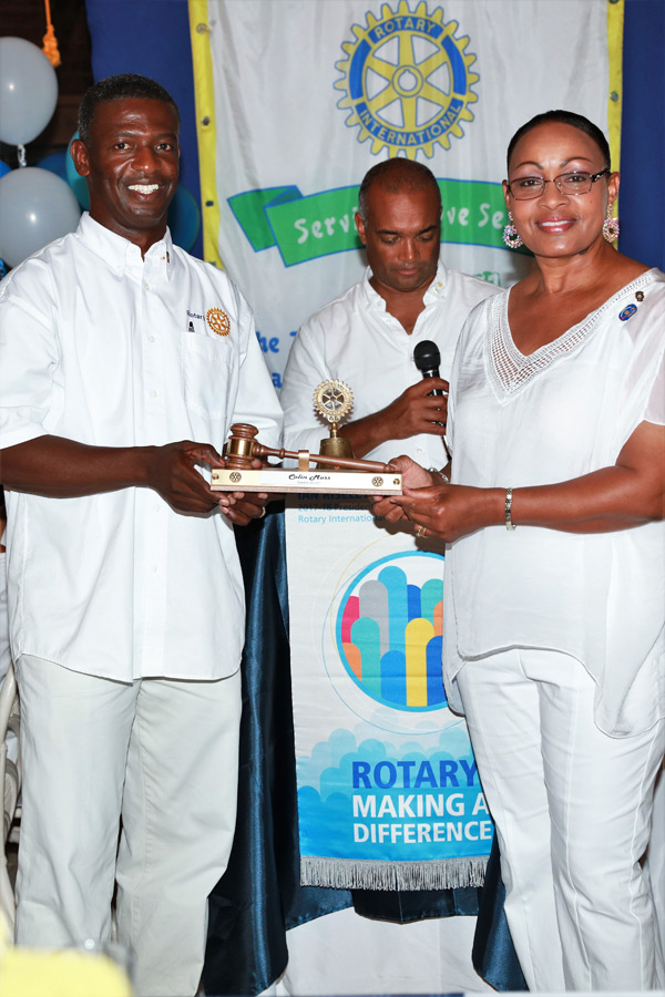 New Rotary Club of Eleuthera President Sherrin Cooper presents the Past President's gavel to Outgoing President Colin Moss.