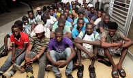 The Haitian migrants seated at the Defence Force Base after they were apprehended at Ragged Island on July 13, 2017.