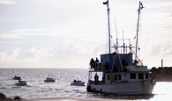 One of the apprehended vessels with skiffs in tow entering the Coral Harbour Base.