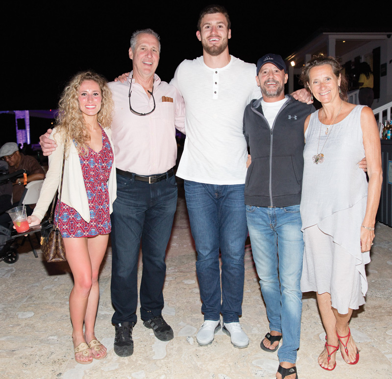 Professional football player, Jesse James (center) with friends, along with girlfriend, Alex Lauth (left) next to her father, Eddie Lauth at French Leave’s Jazz Fest event. 