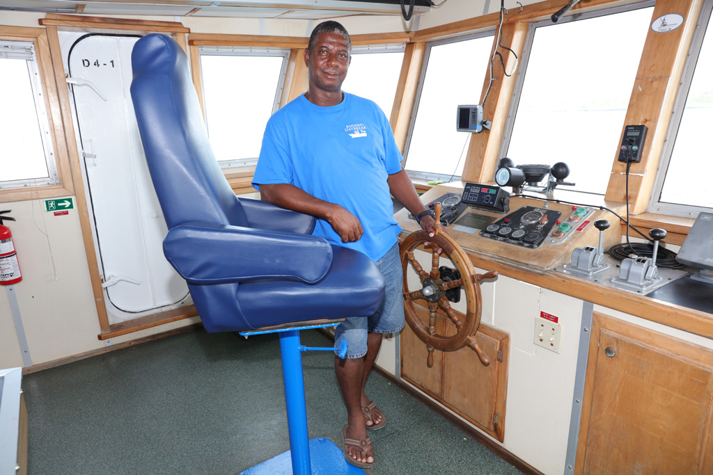Captain Lucitas Greene at the helm of the new Bahamas Daybreak.