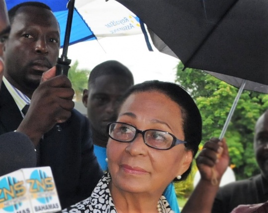 ADC Carlis Blatch standing over GG Dame Marguerite Pindling as she llaid a wreath at the mausoleum of her late husband, former Prime Minister the Rt. Hon. Sir Lynden Pindling.