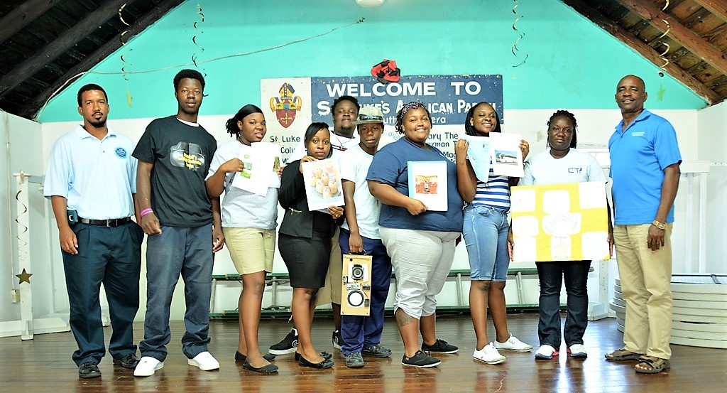Participants of the Innovation Competition happily display their ideas for future businesses flanked by the competition judges. From L-R: Competition judge Kenwood Cartwright, students Randall Tynes, Peaches Sweeting, Kendy Thompson, Drexal Butler, Edrick Munroe, Jasmine Brown, Dariana Michel, Breandra Whylly, and competition judge Errol McPhee.