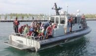 RBDF photo shows: Haitian migrants entering the Defence Force Base aboard patrol craft P-45. (Photo by Chief Petty Officer Jonathan Rolle)
