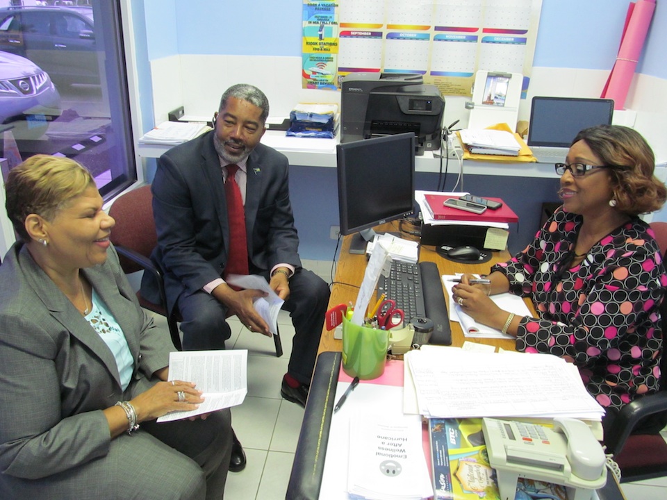 Mrs. Cheryl Carroll, Chief Probation Officer, Department of Rehabilitative Welfare Services (right), who heads the Help Desk, provides a progress report to Minister of Social Services and Urban Development, the Hon. Frankie A. Campbell, during a recent visit. Also pictured is: Mrs. Lilian Quant-Forbes, Director, Department of Social Services, Ministry of Social Services and Urban Development. (BIS Photo/Matt Maura)