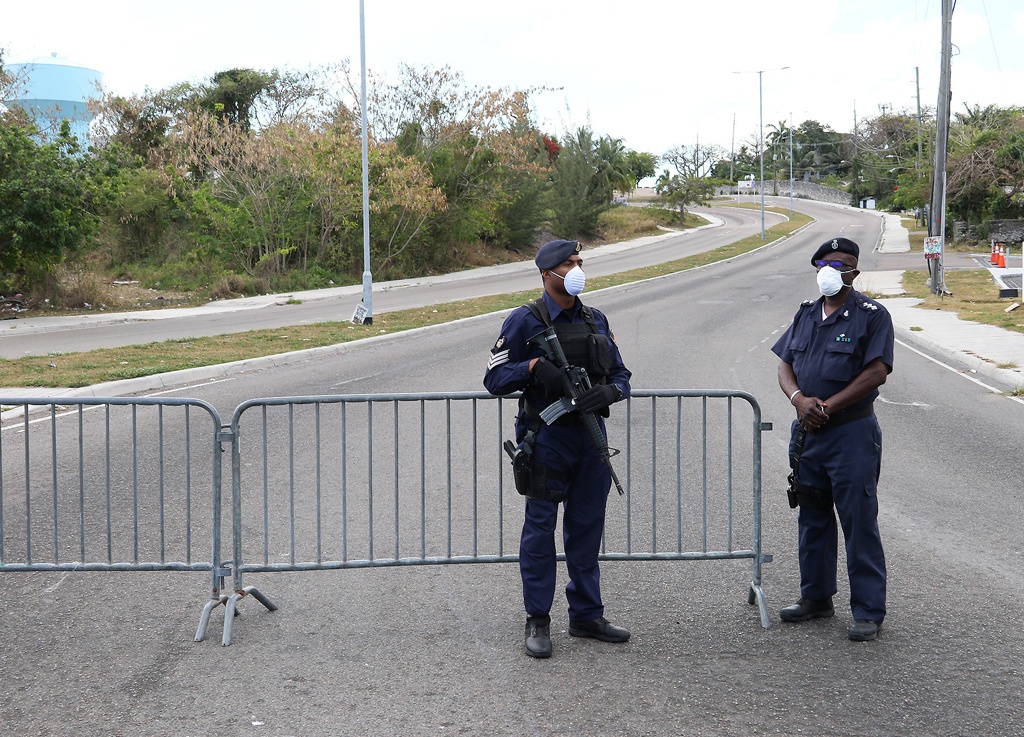 Police manning barricades on streets in New Providence, empty of normal traffic during the weekend country-wide lock down.