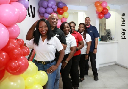 ALIV Governor's Harbour store team members all smiles as they celebrate 5 years in business.