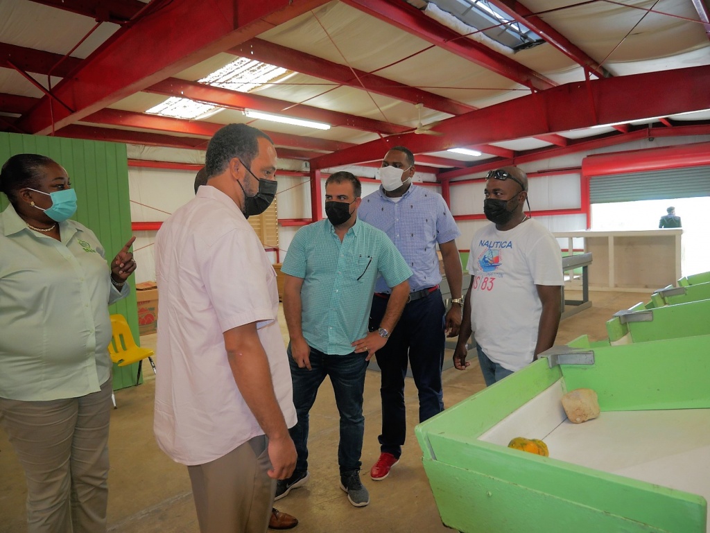 Minister of Agriculture, Marine Resources and Family Island Affairs the Hon. Clay Sweeting, Parliamentary Secretary in the Ministry Leonardo Lightbourne, Executive Chairman of BAMSI, Sen. the Hon. Tyrel Young and Executive Chairman of BAIC, Leroy Major, speak with staff at the Packing House at Green Castle.