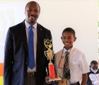 Sohan Bryan of Central Eleuthera High School - 1st Place Eleuthera District Spelling Bee Winner stands with District Superintendent of Education, Mr. Michael Culmer.
