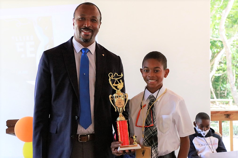  Sohan Bryan of Central Eleuthera High School - 1st Place Eleuthera District Spelling Bee Winner stands with District Superintendent of Education, Mr. Michael Culmer.