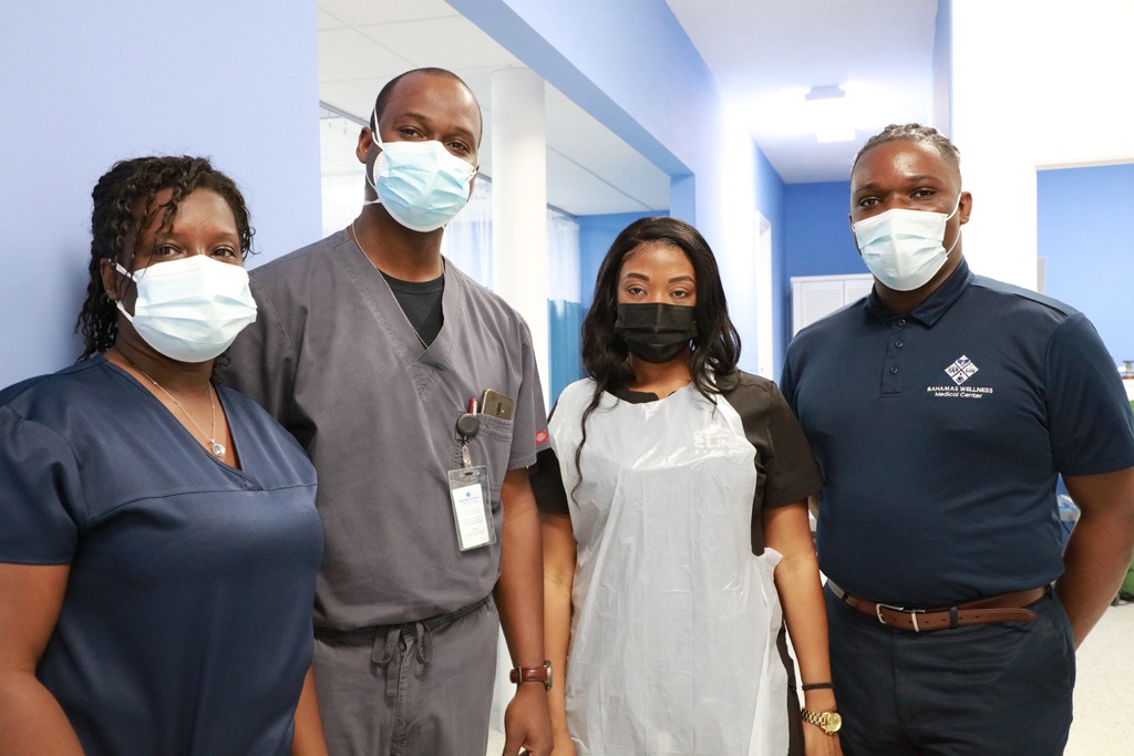 Above: Dr. Arlington Lightbourne (center left) stands with members of his medical services team at the Bahamas Wellness Eleuthera Medical Center.