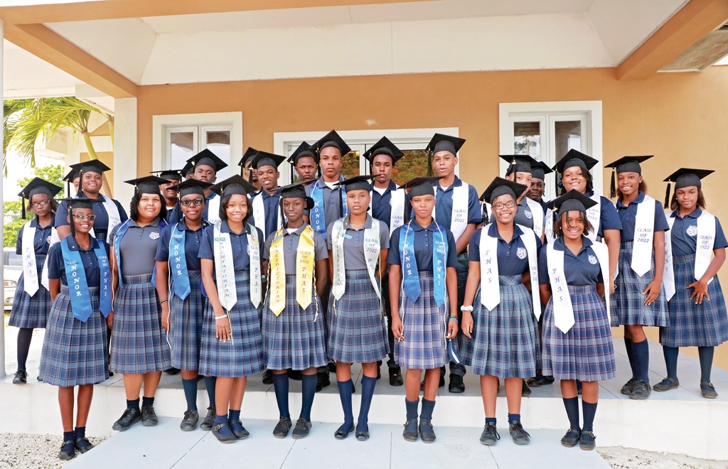 Preston H. Albury High School's Class of 2022 stand in front of Fountain of Life Kingdom Ministries church, ahead of their celebratory parade as new graduates.