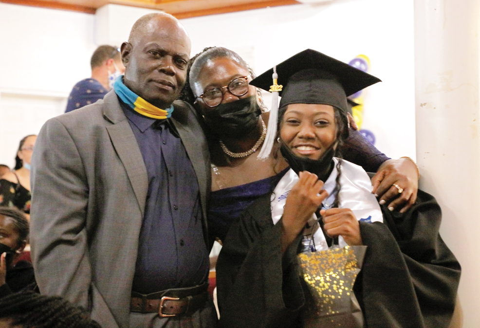 Salutatorian of Samuel Guy Pinder All Age School's (SGPAAS) Class of 2022 - Caurthney Noel being warmly embraced by her parents at the SGPAAS graduation ceremony, hosted at the Methodist Church in Spanish Wells on Wednesday, June 22nd, 2022.