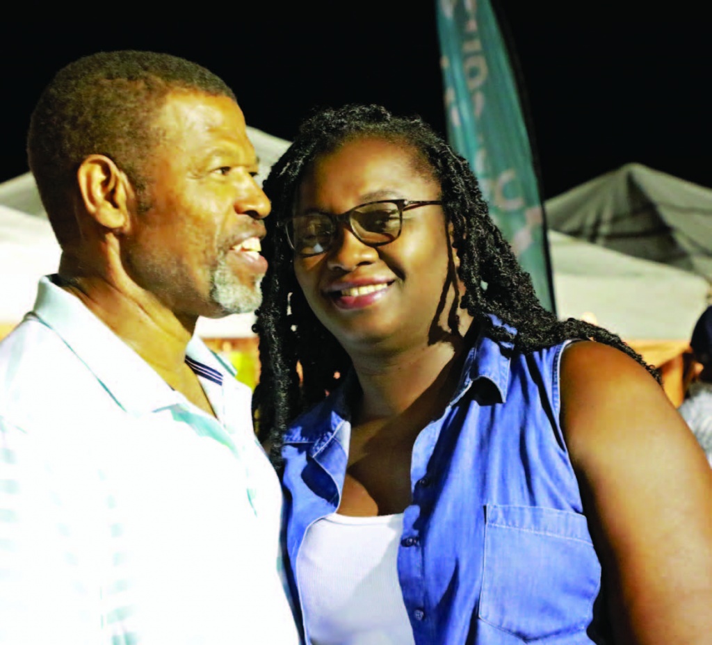 Couple enjoys the music, food, and cultural entertainment at Goombay Festival in JC.