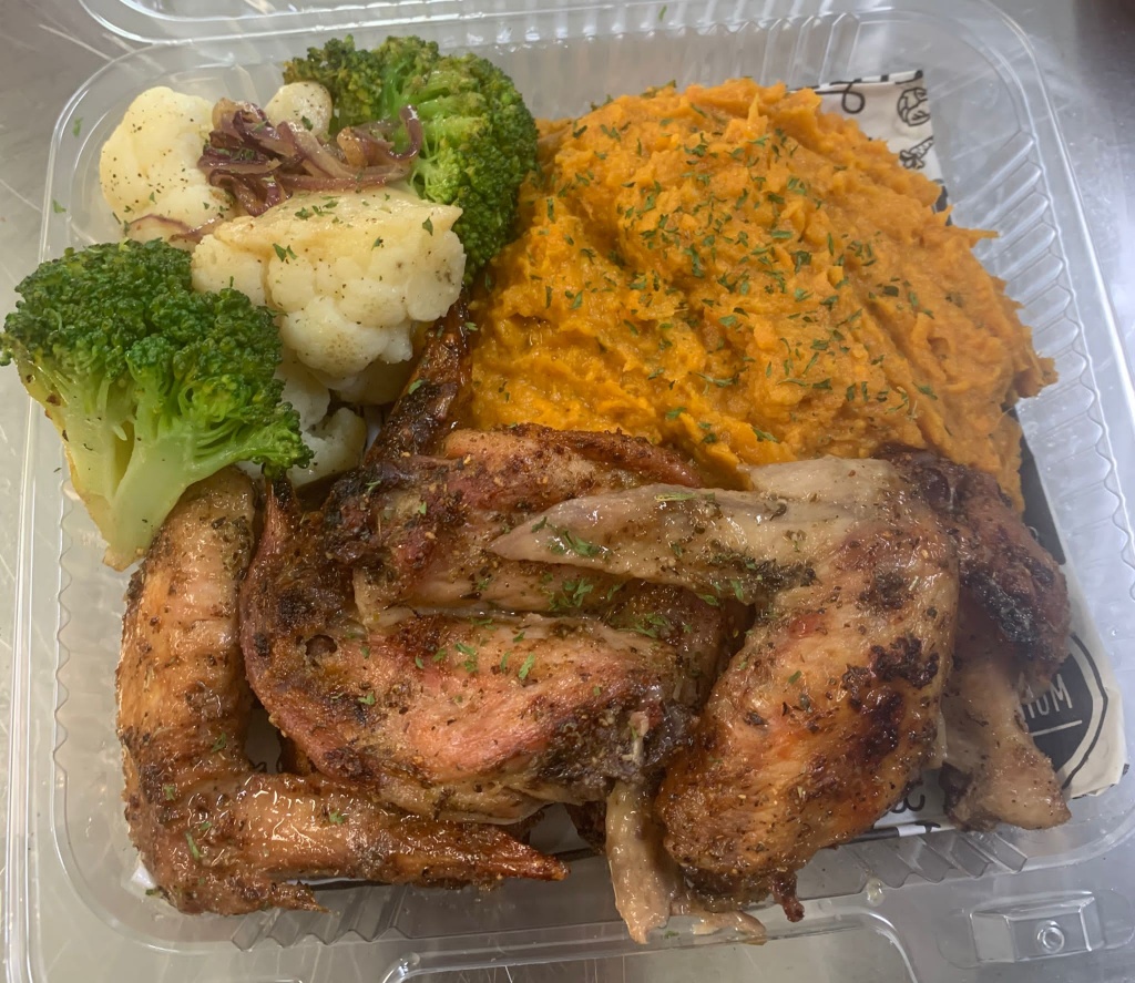 A healthy spin on a Bahamian staple: Herb-baked chicken wings, smashed sweet potato & crisp, steamed veggies.