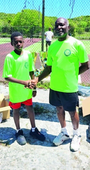 Pictured: Youngest participant, Ayai Bethel, with tournament sponsor, Tim Dames.