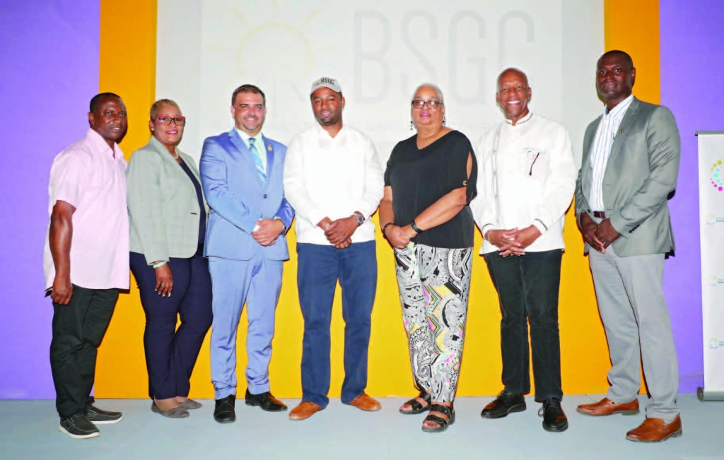 BSGC principals, CEO Atario Mitchell, and general manager, Melanie Roach (center), flanked on left by Minister Clay Sweeting, and on the right by Minister Alfred Sears, along with island administrators Stephen Wilson (end left), Florence Pratt-Meyer (2nd from left), and Earl Campbell (end right).