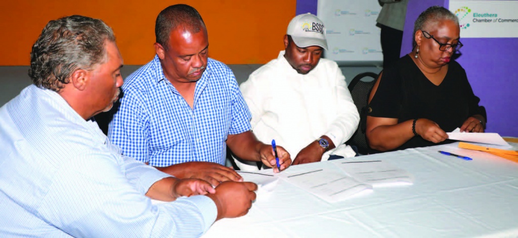 Owners of Nu View Construction, Philip kemp and Peter kemp (seated left), sign MOU with BSGC CEO Atario Mitchell (center right), and BSGC general manager, Melanie Roach (end right).