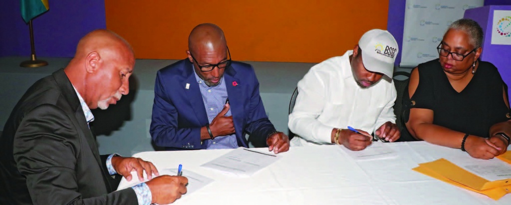 Owners of Quick Fix Construction, Elton Symonette and Edrin Symonette (seated left), sign MOU with BSGC CEO Atario Mitchell (center right), and BSGC general manager, Melanie Roach (end right).