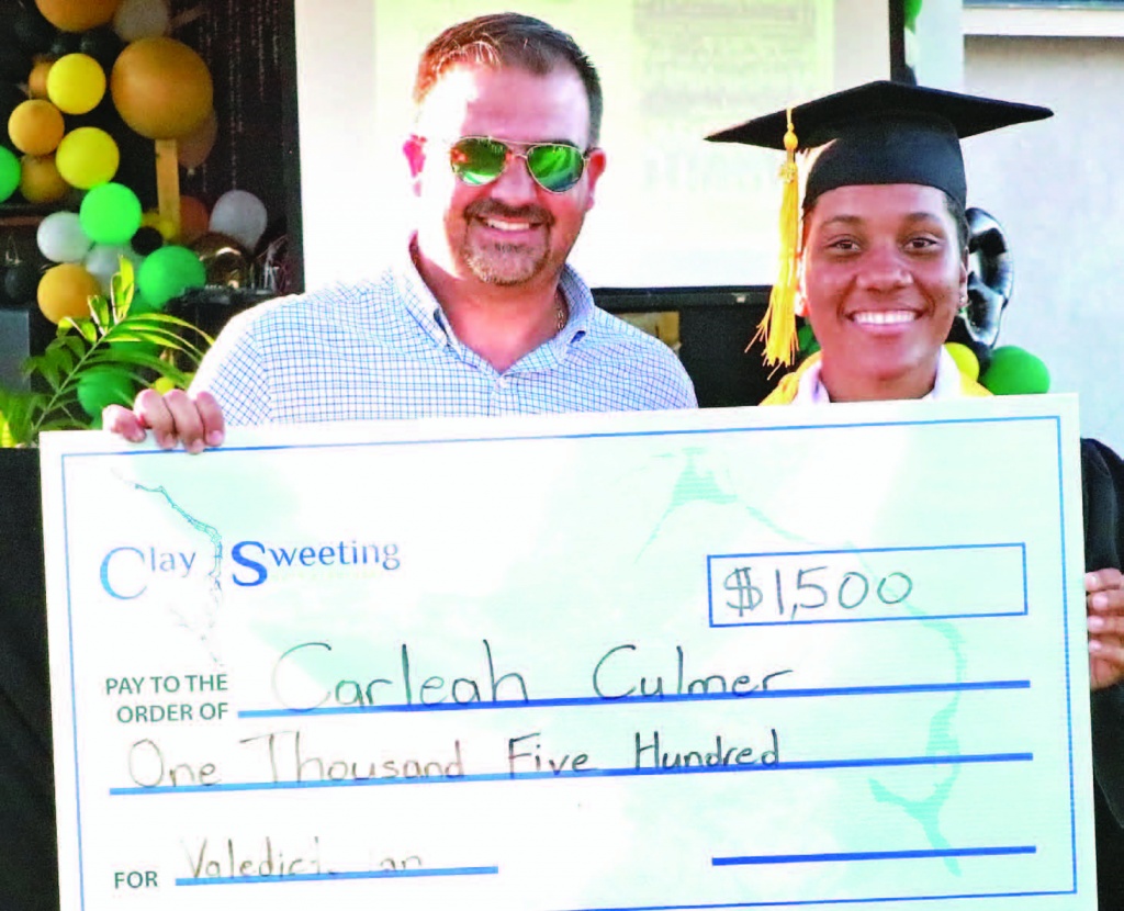 MP Clay Sweeting, presenting a scholarship prize from the constituency to CEHS valedictorian, Carleah Culmer. The same prize was presented to top students across the island during graduation season.