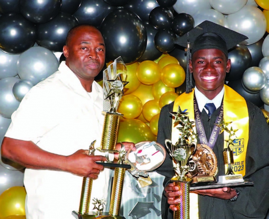  Zephon McAndrew, Valedictorian at Samuel Guy Pinder All Age School, presented with his diploma and awards by MP NE, and Deputy Speaker, Mr. Sylvanus Petty.