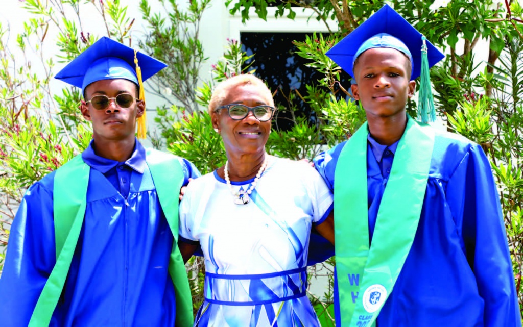 Windermere High School graduates, Caleb Pedican (left) and Jaron Lloyd (right) stand proudly with their principal, Mrs. Myrtle McPhee.
