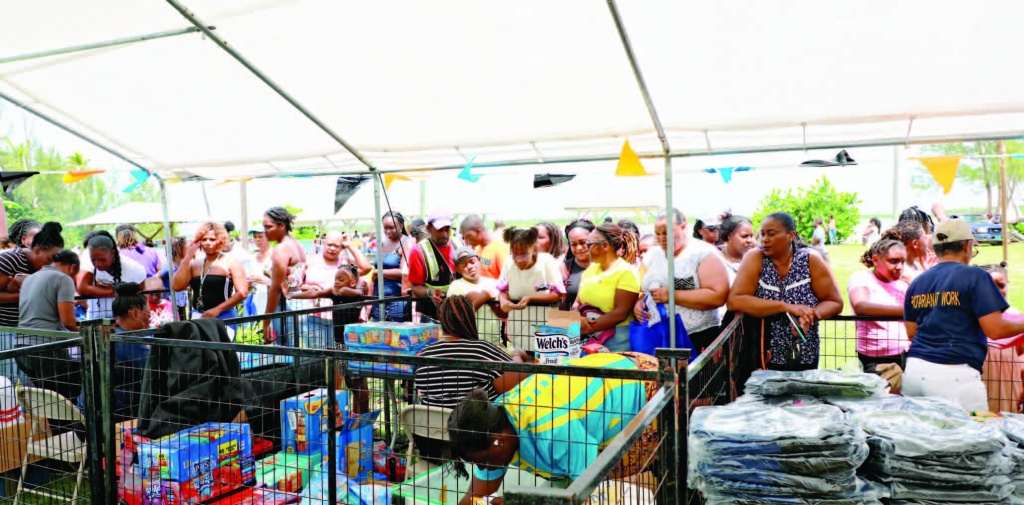 Parents and students took full advantage of the well-planned giveaway on the park in Savannah Sound with volunteers assisting. Supplies were piled up in the different booths as residents 'shopped' for school supplies.