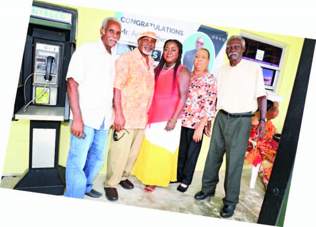 Mr. Nixon (second from left) stops to pose with his family members, during his 50-year celebration event.