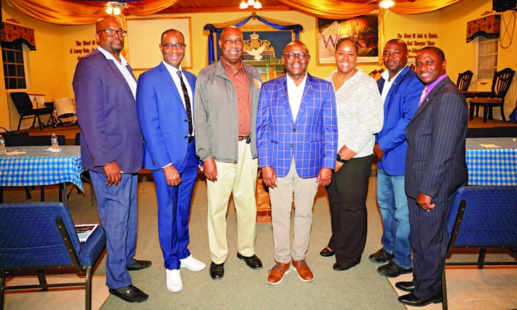 Officials with the Ministry of Tourism, Investments and Aviation, and Ministry of Works stand with DPM Chester Cooper (center), NE MP Sylvanus Petty (2nd from right) and NE Administrator Stephen Wilson (on right end).