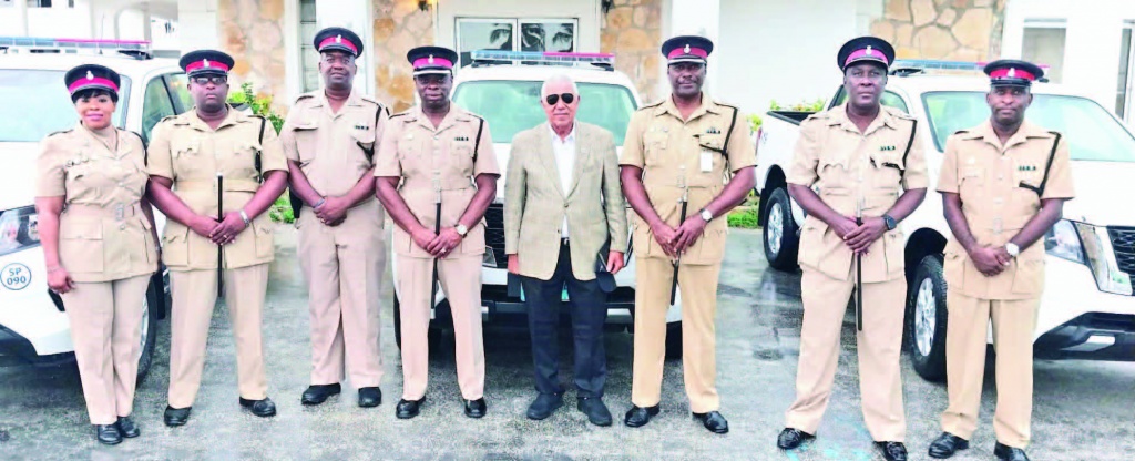 Eleuthera Officers with Rev. Philip Bethel, at a short prayer session, dedicating three new vehicles to the work of the police.
