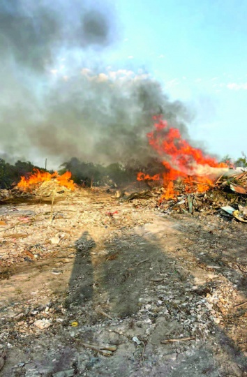 Piles of rubble from demolished structures on fire in North Eleuthera.