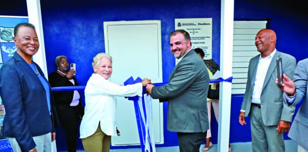 The cutting of the ceremonial ribbon by Minister Glenys Hanna-Martin, and Minister Clay Sweeting as BTVI president Dr. Linda Davis, and Housing Minister Keith Bell, look on.