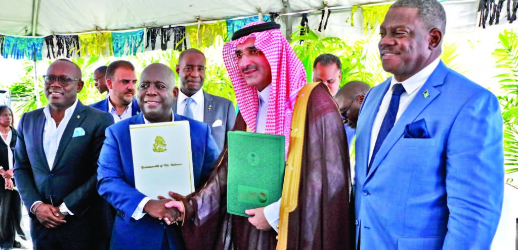 Prime Minister and Minister of Finance, the Hon. Philip Davis (center left), exchanges a handshake with His Excellency Sultan Abdulrahman Al-marshad, Chief Executive officer, Saudi Fund for Development (center right), during the signing ceremony for a $55 million loan agreement. Also seen is Deputy Prime Minister and Minister of tourism, Investments and Aviation, the Hon. Chester Cooper (end left), and Paul Bevans, Chairman, Airport Authority (end right).