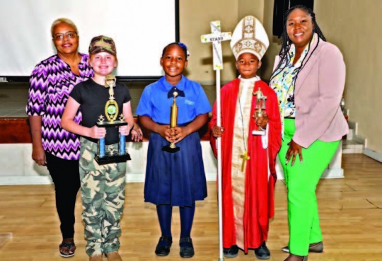 Winners stand with officials after a well-fought contest (L-R); Chief Judge Mrs. Althea Roberts, Sadie Pinder (1st Place), Keyanna Simon (2nd Place), Timothy Morley (3rd Place), and DEO Mrs. Fontella Knowles.