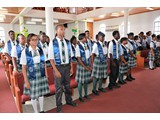 Graduates proudly standing after their entrance into the church -490A6913