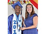 Valedictorian of the WHS Class of 2016, Naaman Rolle, receiving an award in Mathematics from teacher Ms. Parks - 490A3268
