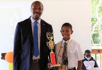 Sohan Bryan of Central Eleuthera High School - 1st Place Eleuthera District Spelling Bee Winner stands with District Superintendent of Education, Mr. Michael Culmer.