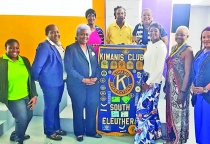 Pictured: Newly installed South Eleuthera Kewanis Club President Meredith Atwood (front center right of podium), stands with Kiwanis Dicision 22 lieutenant Governor Anastasia Johnson (fribnt center left of podium), along with South Eleuthera Kiwanis Club members, and with visiting guests.