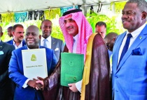 Prime Minister and Minister of Finance, the Hon. Philip Davis (center left), exchanges a handshake with His
Excellency Sultan Abdulrahman Al-marshad, Chief Executive officer, Saudi Fund for Development (center right), during
the signing ceremony for a $55 million loan agreement. Also seen is Deputy Prime Minister and Minister of tourism, Investments and Aviation, the Hon. Chester Cooper (end left), and Paul Bevans, Chairman, Airport Authority (end right).