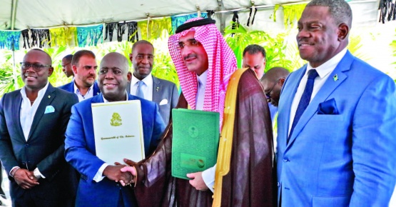 Prime Minister and Minister of Finance, the Hon. Philip Davis (center left), exchanges a handshake with His
Excellency Sultan Abdulrahman Al-marshad, Chief Executive officer, Saudi Fund for Development (center right), during
the signing ceremony for a $55 million loan agreement. Also seen is Deputy Prime Minister and Minister of tourism, Investments and Aviation, the Hon. Chester Cooper (end left), and Paul Bevans, Chairman, Airport Authority (end right).